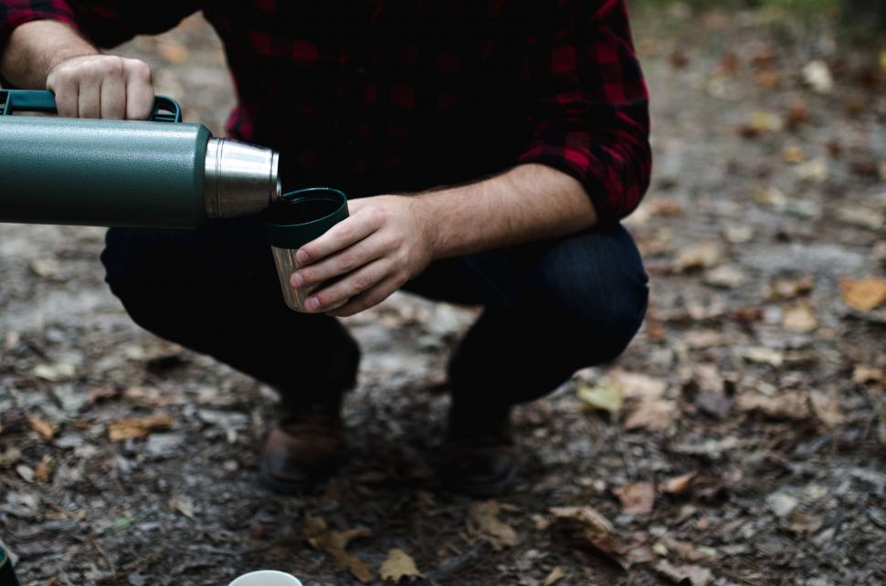 Free Image of Man pouring from thermos into cup 