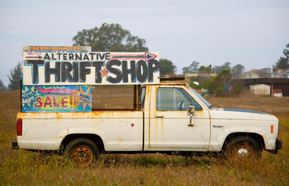 Free Image of Old truck with colorful thrift shop sign 