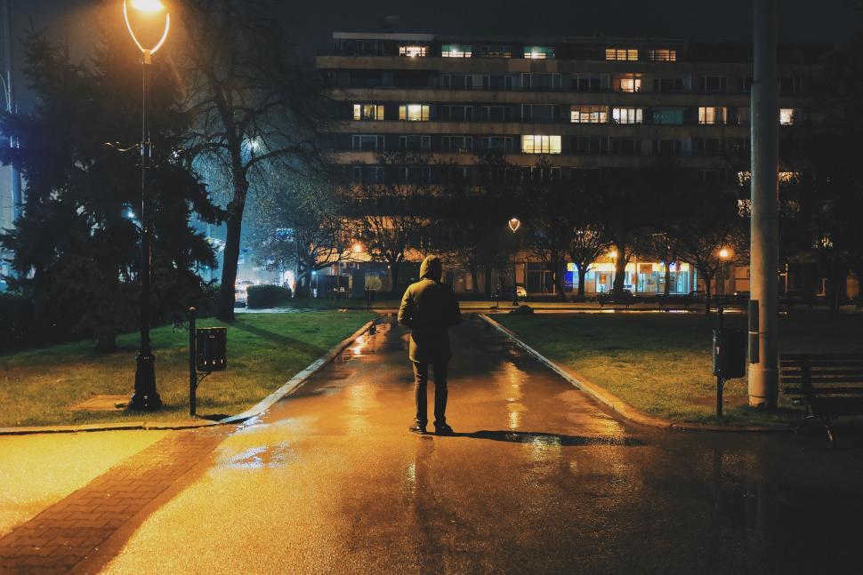 Free Image of Person walking on a rainy night in the park 