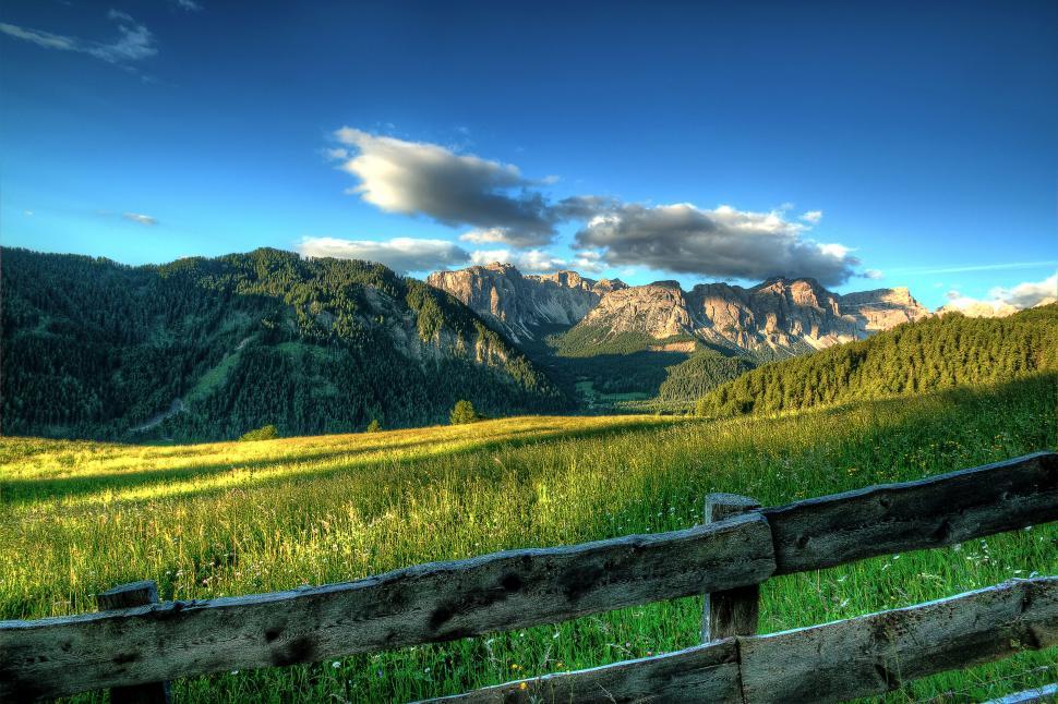 Free Image of Idyllic mountain view from a grassy hill 