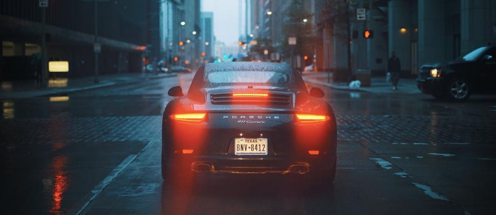 Free Image of Porsche 911 Carrera in Rainy City Streets 