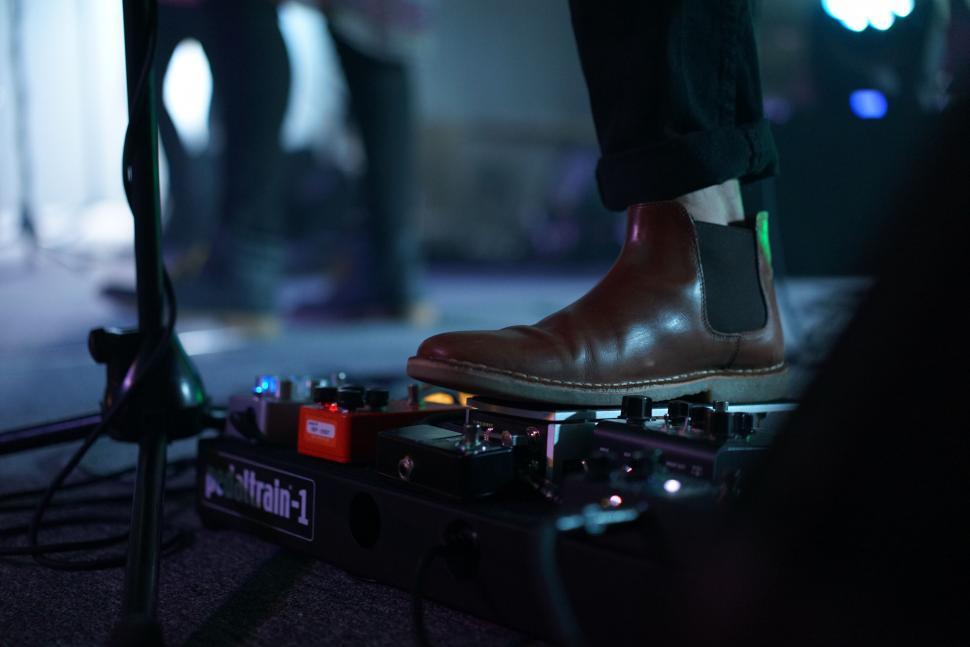 Free Image of Close-up of guitar pedalboard on stage 