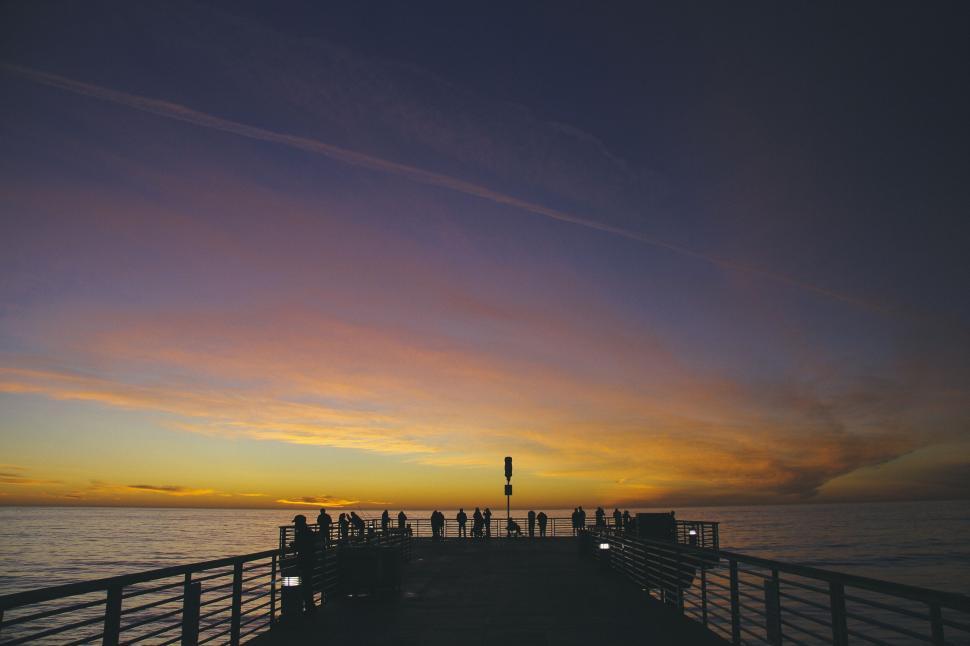 Free Image of People on pier during radiant sunset 