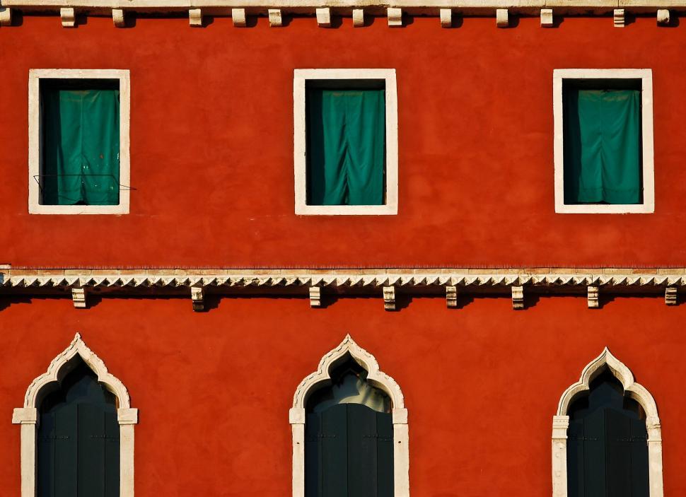 Free Image of Vibrant orange wall with green window shutters 