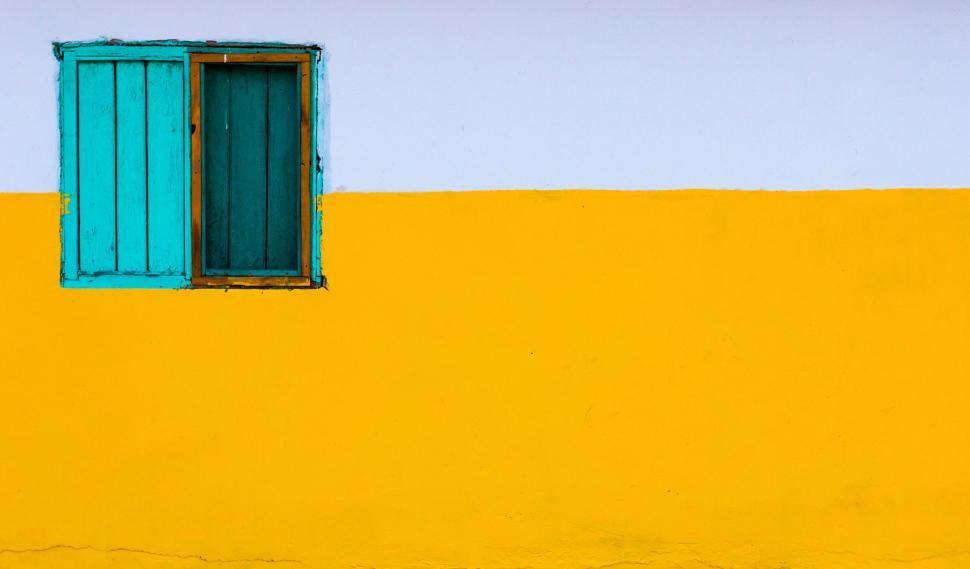Free Image of Minimalist yellow wall with blue window 