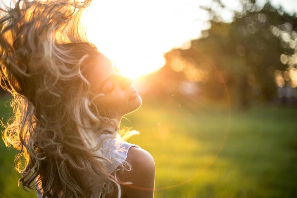 Free Image of Woman basking in sunset s golden light 