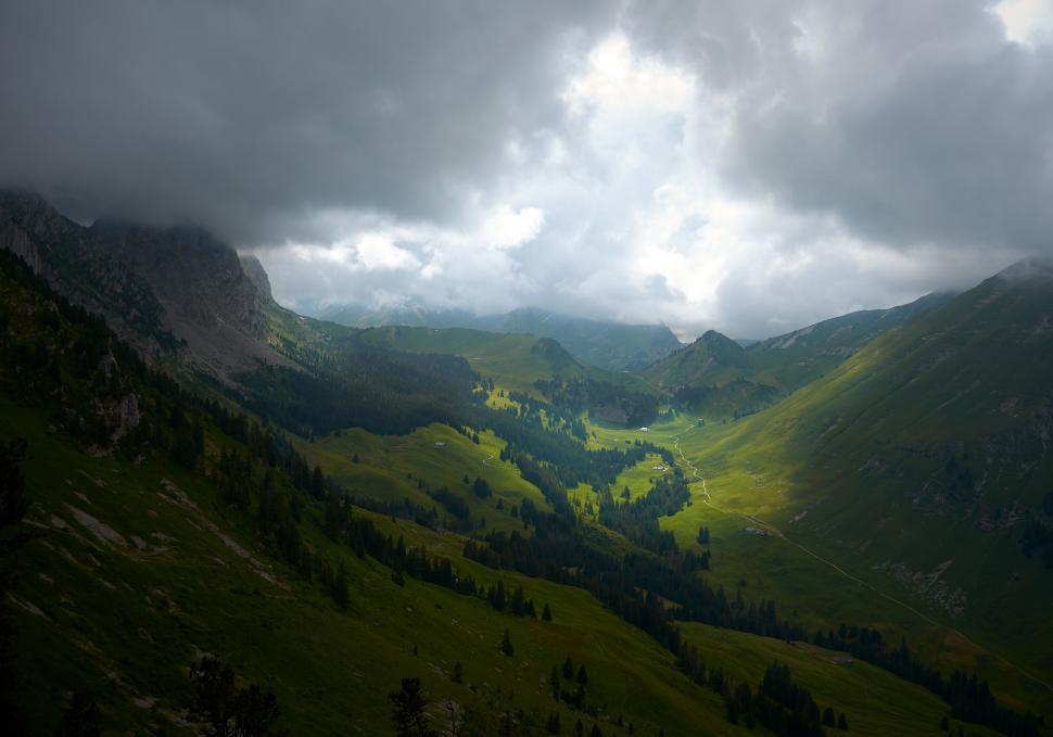 Free Image of Mystical mountain valley with cloudy skies 