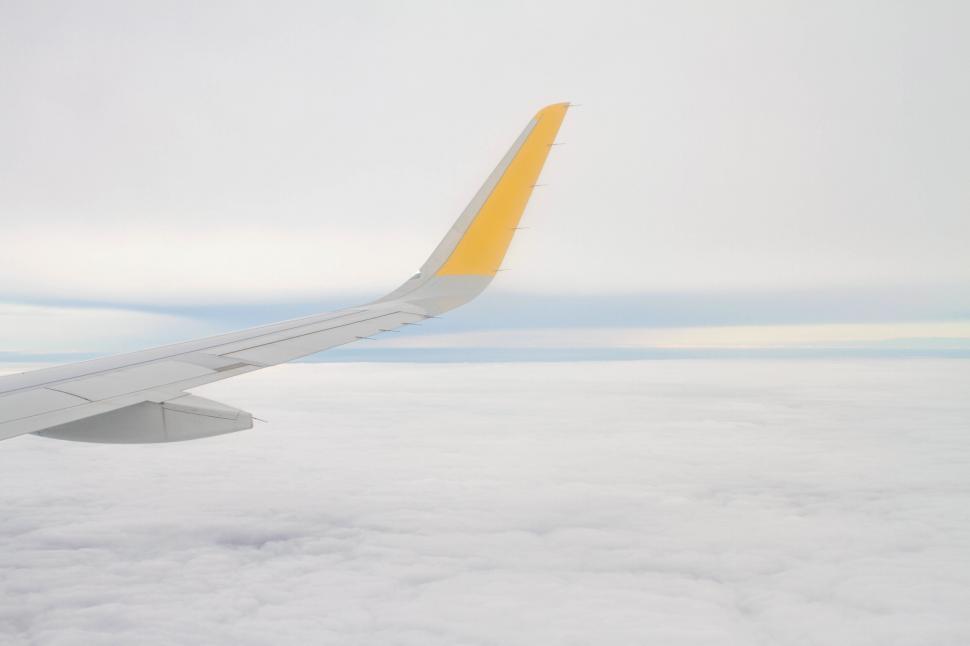 Free Image of Airplane wing against cloudy sky 