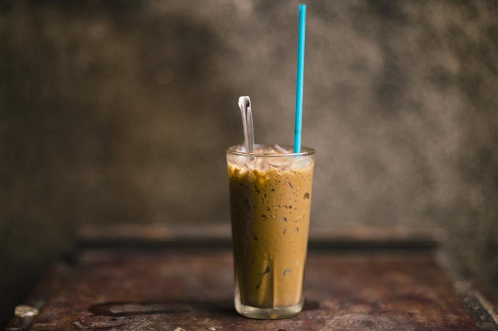 Free Image of Iced coffee in a tall glass with straw 