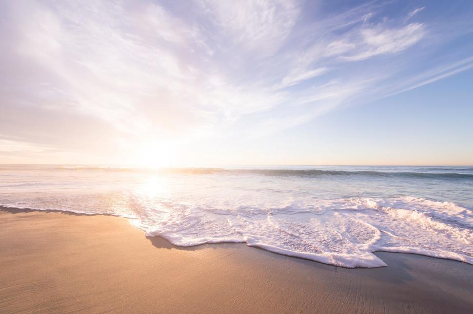 Free Image of Serene beach sunrise with gentle waves 
