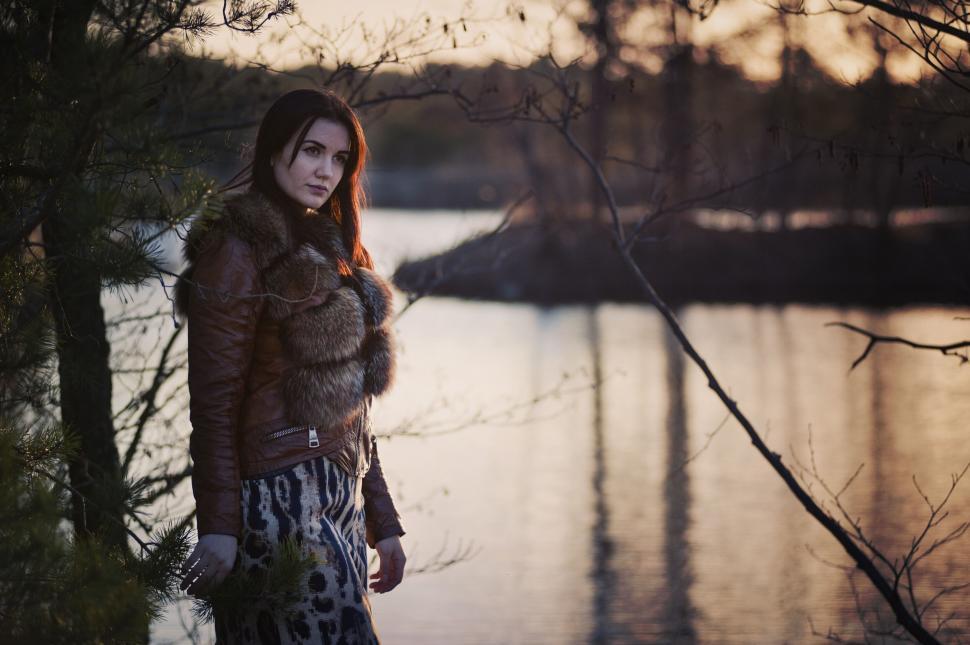 Free Image of Woman in winter clothing beside lake 