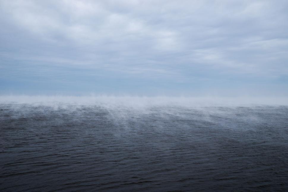 Free Image of Sea with sea smoke rising on a cold day 