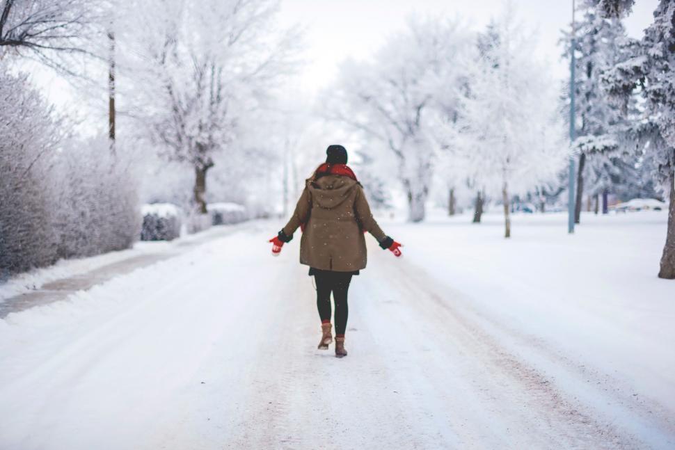 Free Image of Person walking on snowy road 