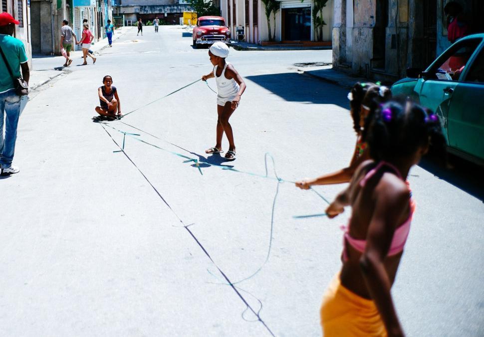 Free Image of Children playing with rope on street 