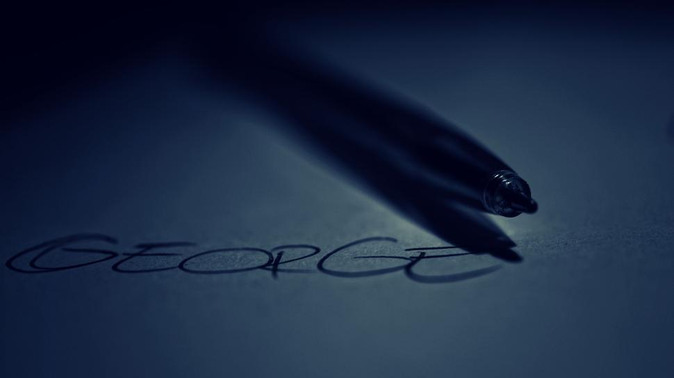 Free Image of Pen writing the name George in low light 