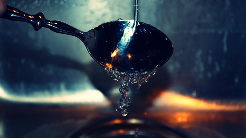 Free Image of Water dripping from a spoon in the sink 