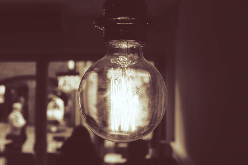 Free Image of Vintage light bulb glowing with filament visible 