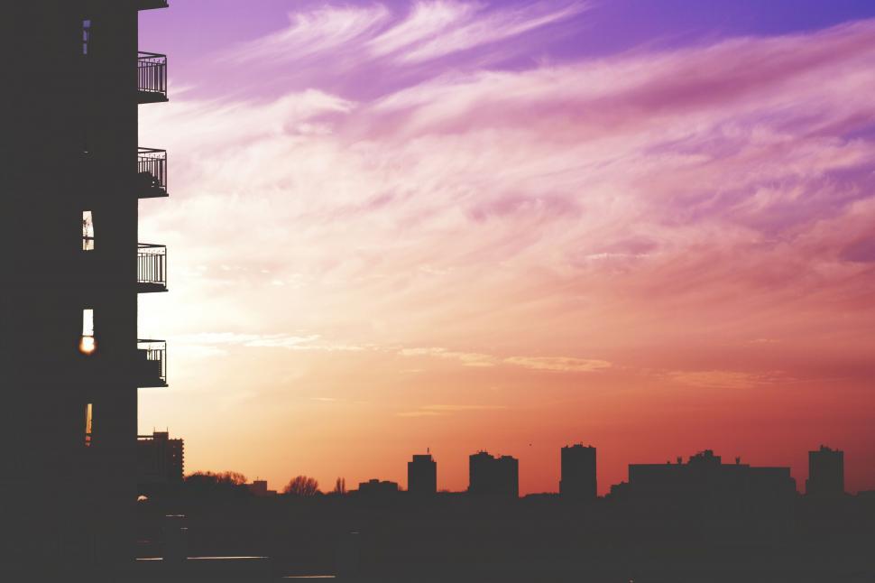 Free Image of Purple-hued sunset beside a building 