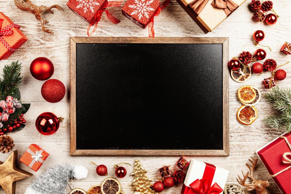Free Image of Chalkboard surrounded by Christmas decor 