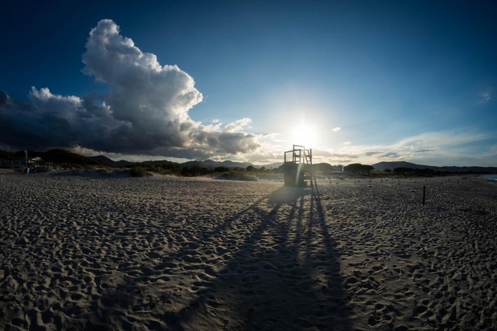 Free Image of Sunset and shadows on a sandy beach 