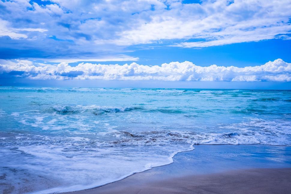 Free Image of Turquoise waves crashing on a sandy beach 