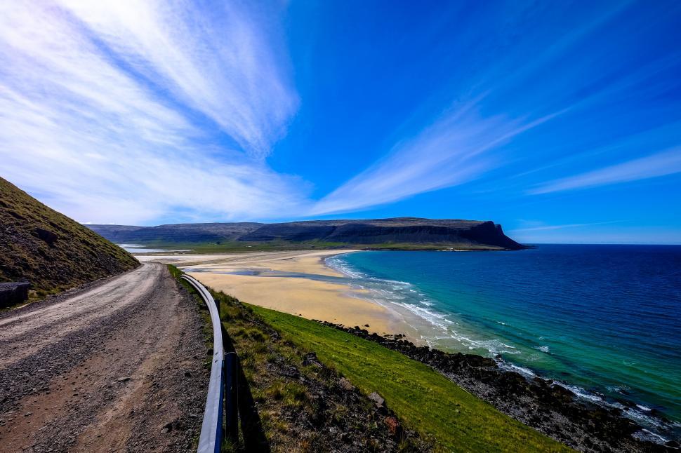 Free Image of Scenic coastal road with vibrant sky 