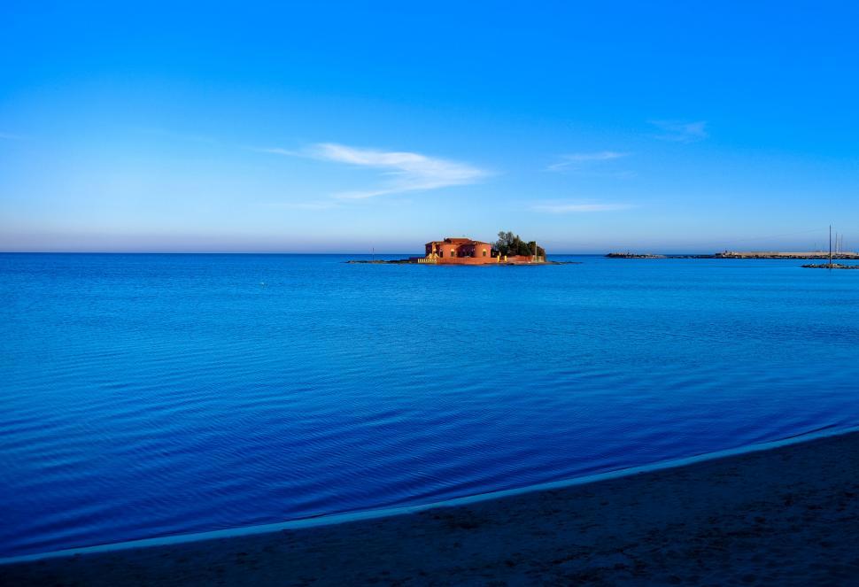 Free Image of Tranquil island in calm blue waters 