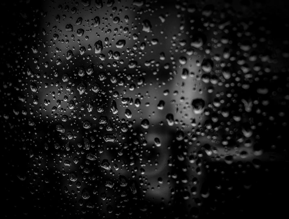 Free Image of Raindrops on a glass window close-up 
