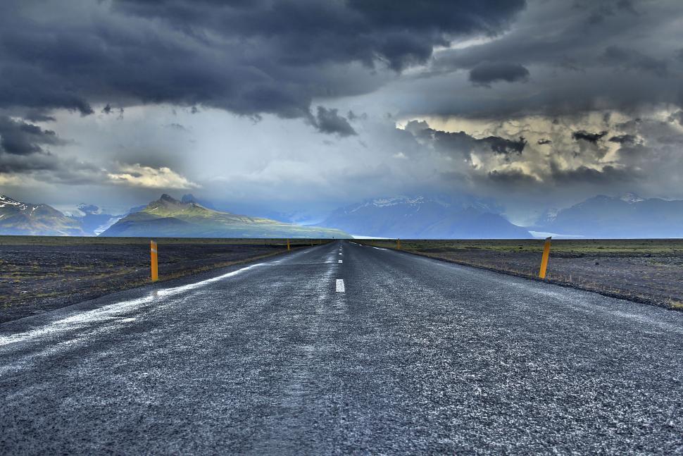 Free Image of Storm clouds over a scenic empty road 