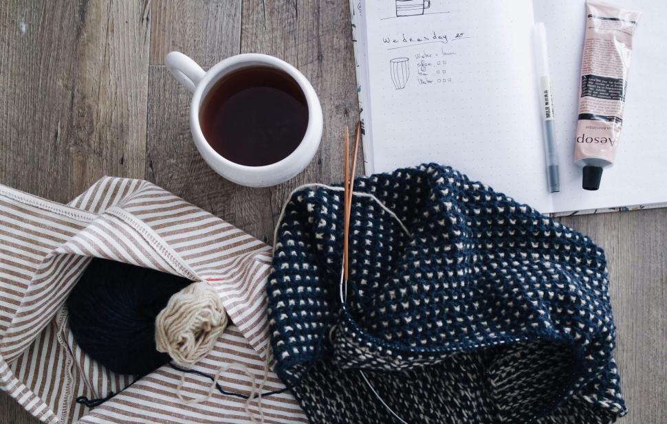 Free Image of Knitting with tea and planner on table 