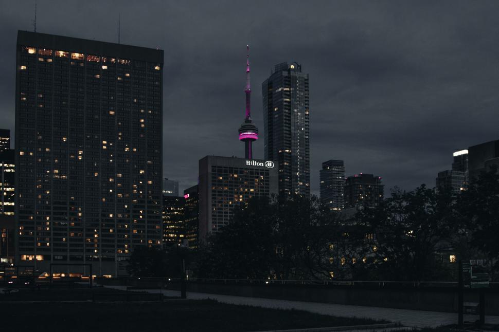 Free Image of Twilight cityscape with illuminated tower 