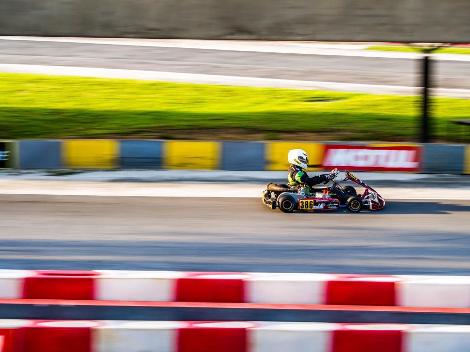 Free Image of Kart racing in motion on a track 