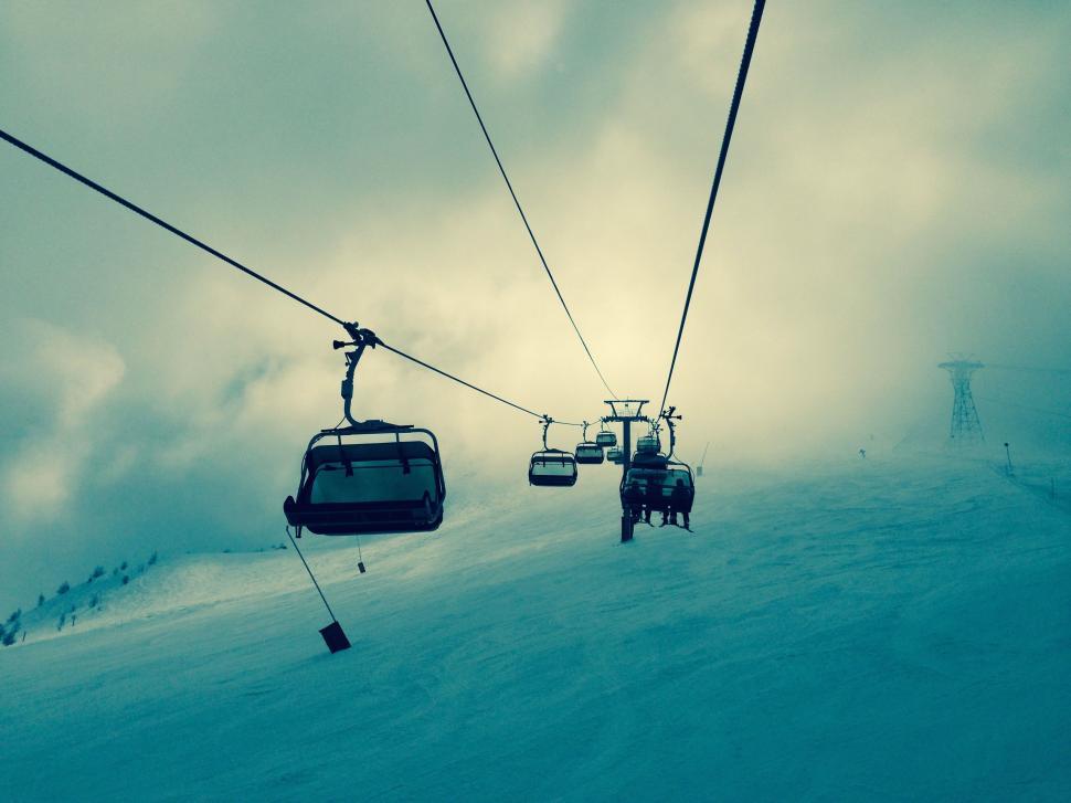 Free Image of Chairlifts over a snowy mountain 