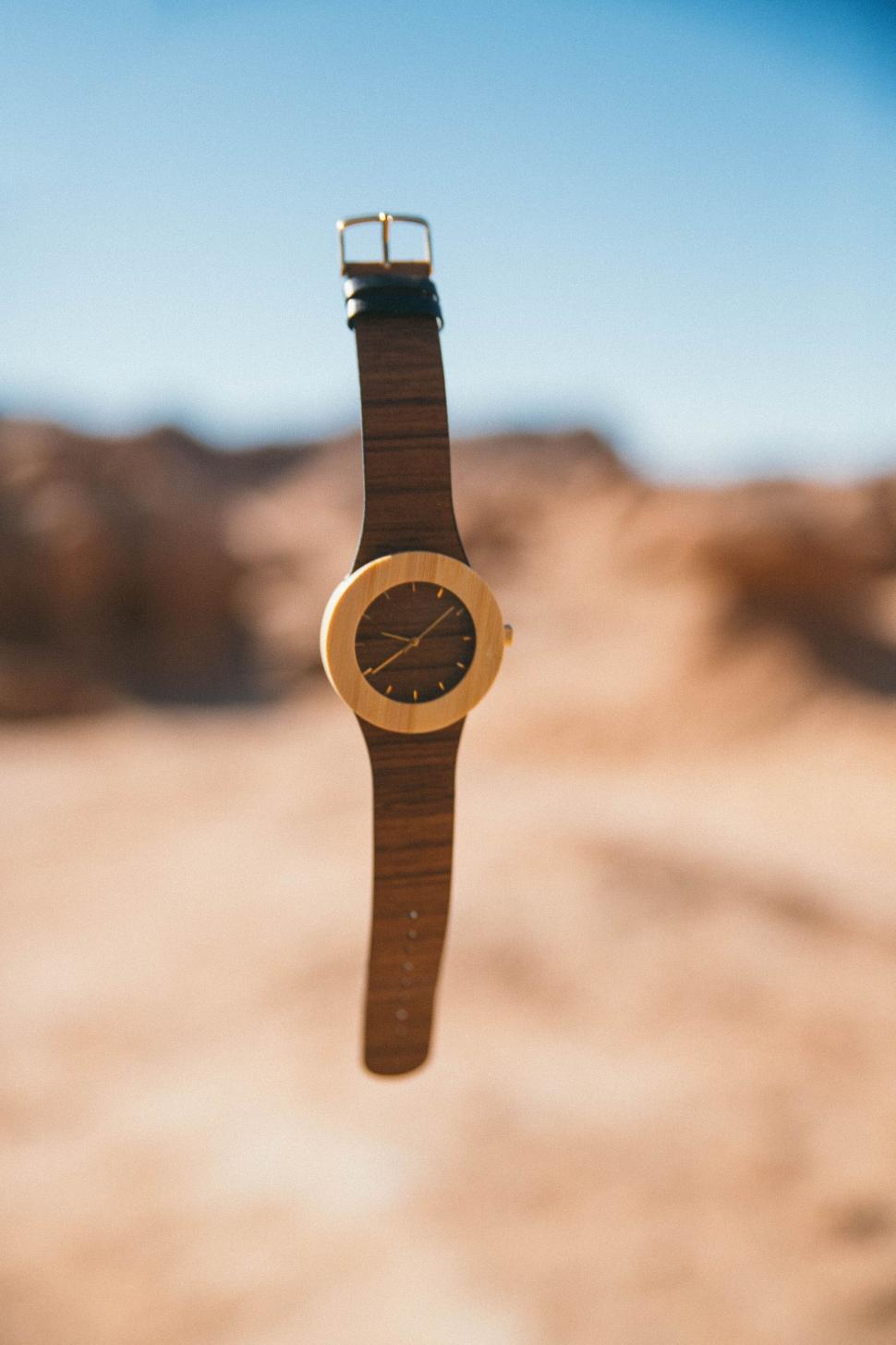 Free Image of Focused wooden watch in a desert 