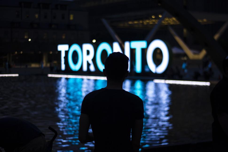 Free Image of Silhouette against Toronto light installation 