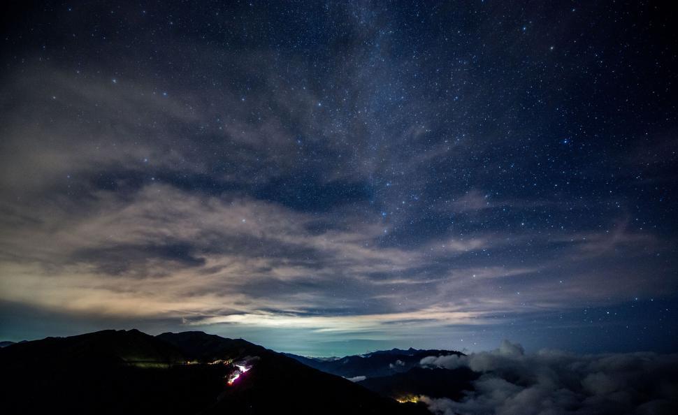 Free Image of Starry night over mountainous landscape 