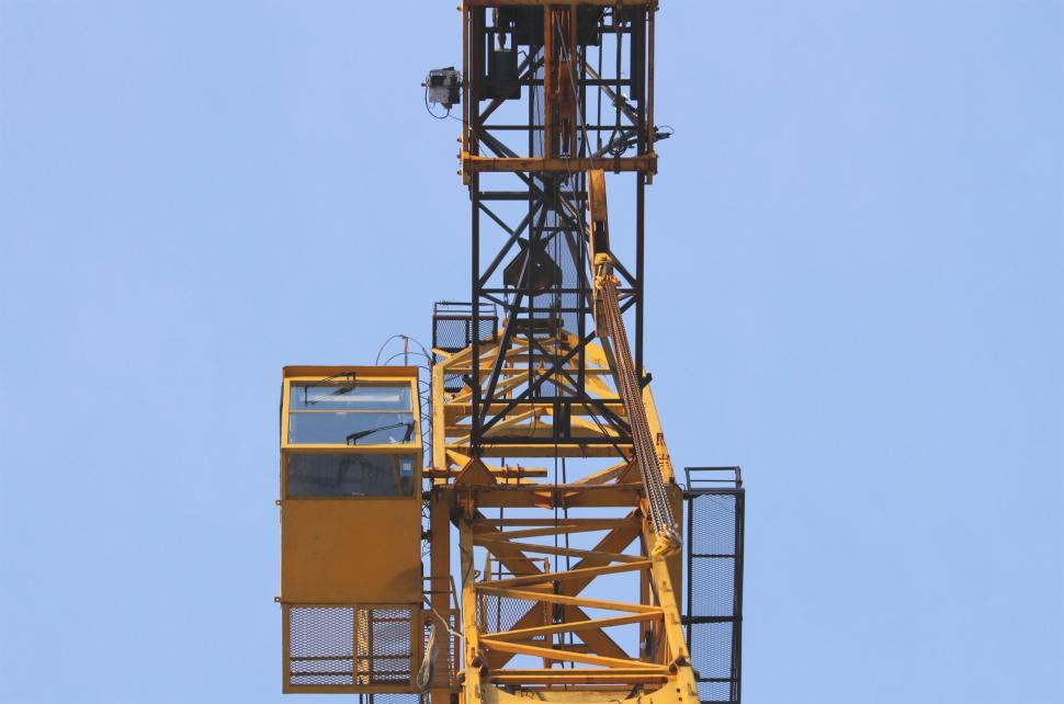 Free Image of Yellow construction crane against a blue sky 