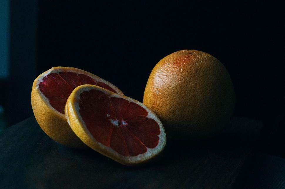 Free Image of Fresh cut grapefruit on a dark background 