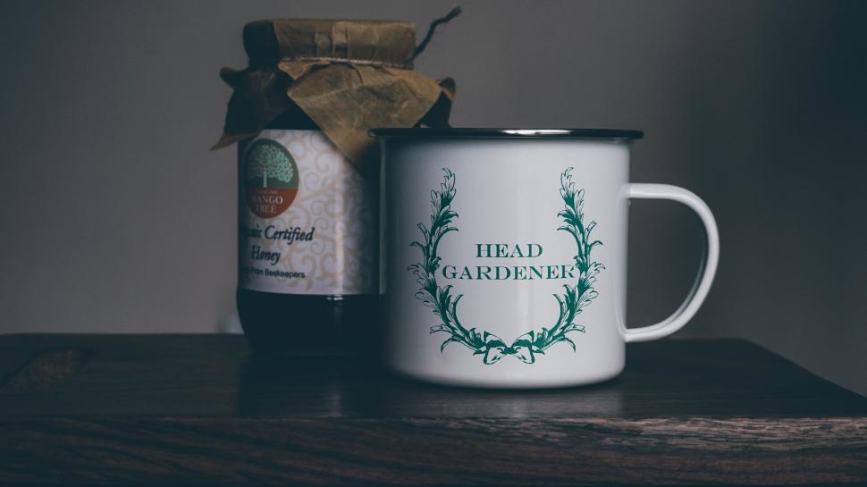 Free Image of Head Gardener mug beside jarred product 