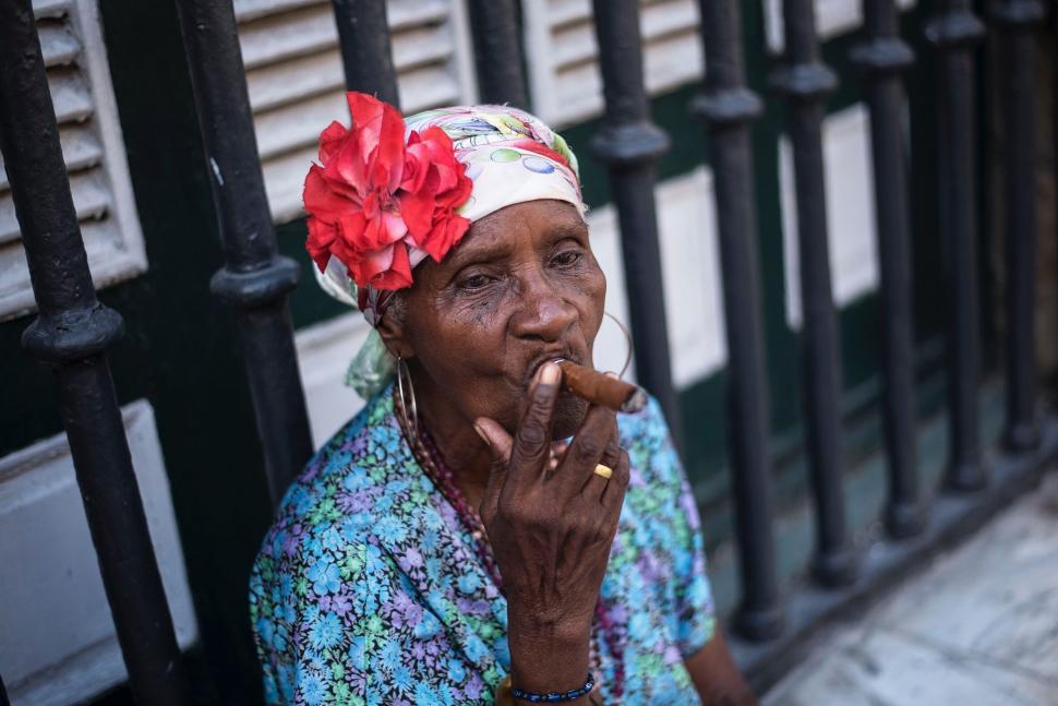 Free Image of Elderly woman smoking on urban street 