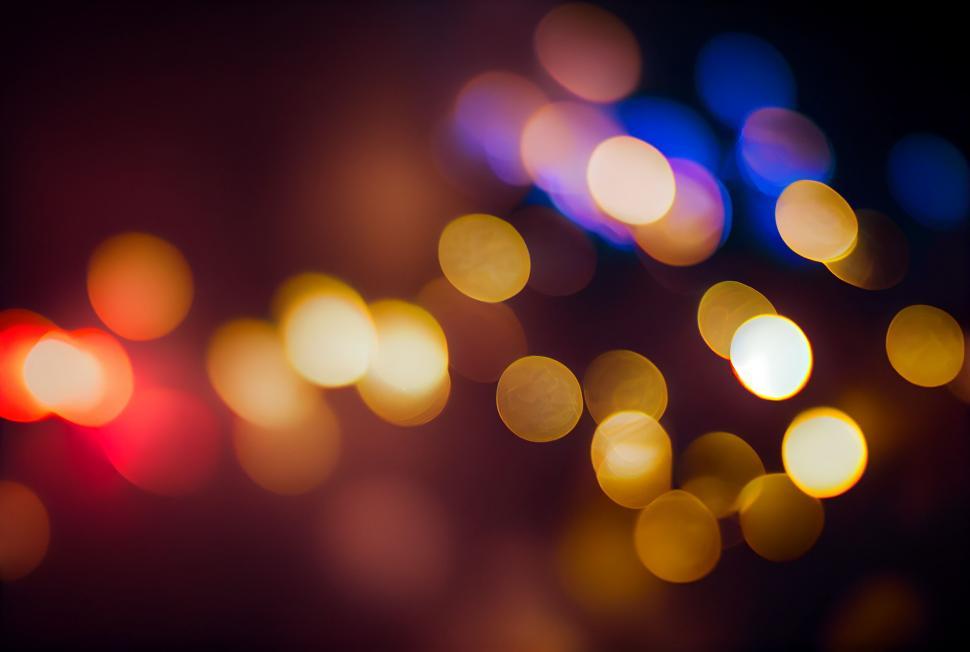 Free Image of Warm bokeh light dots on a dark background 