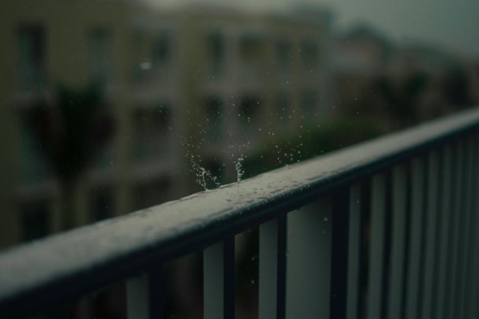 Free Image of Raindrops on balcony railing in gloom 
