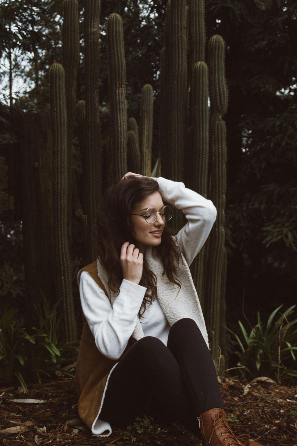 Free Image of Woman sitting among cacti in nature 