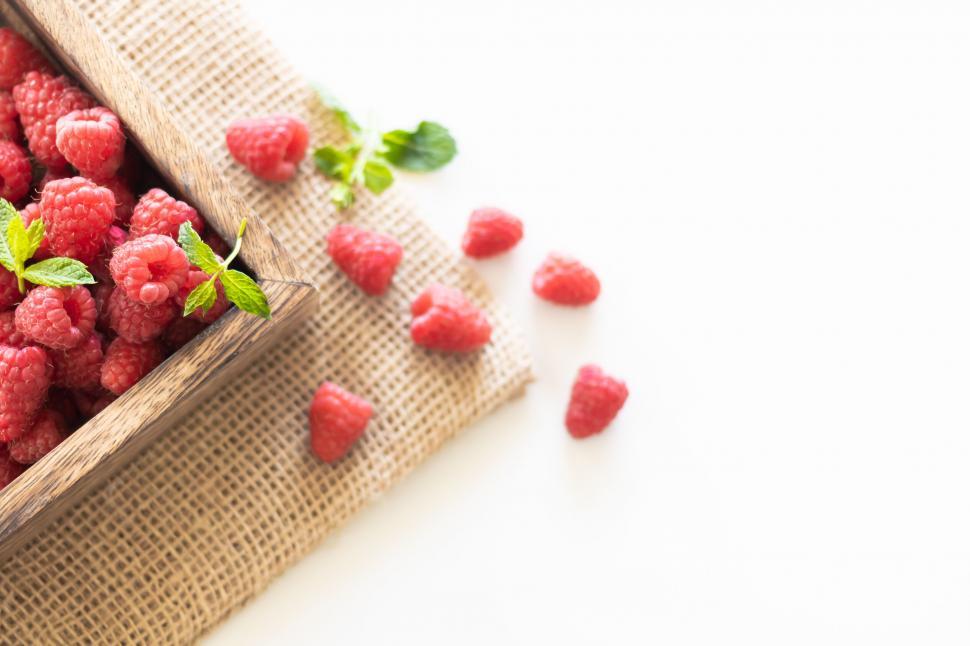 Free Image of Raspberries in wooden tray on burlap 