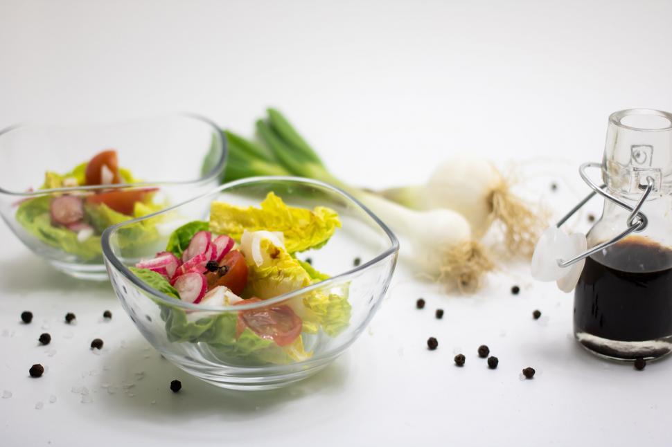 Free Image of Twin salad bowls with ingredients and dressing 