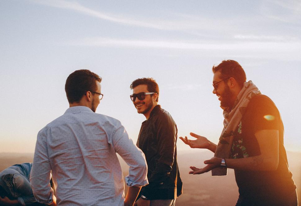 Free Image of Group of friends laughing during golden hour 