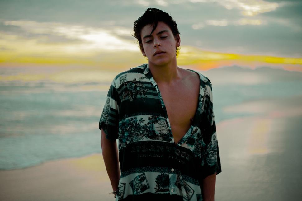 Free Image of Young man on beach at sunset 