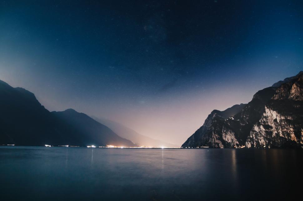 Free Image of Night sky over a calm mountain lake 