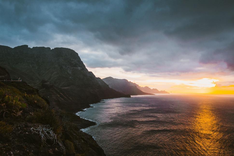 Free Image of Sunset over rugged coastline cliffs 