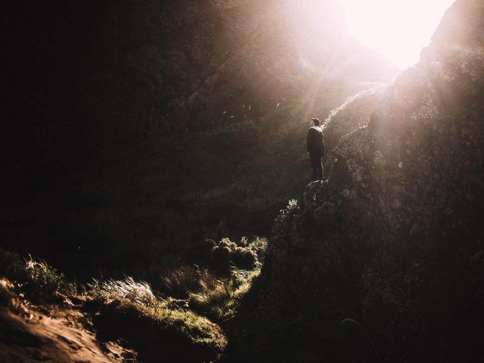 Free Image of Silhouetted figure in mountainous terrain 